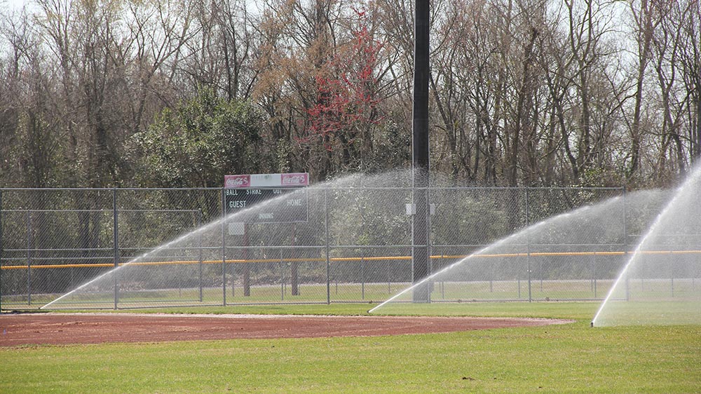 Sprinklers installed by GreenSeasons on baseball field for irrigation
